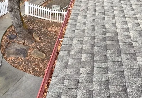 Dirt and debris buildup in a gutter that can lead to foundation-damaging overflow in Richmond, VA