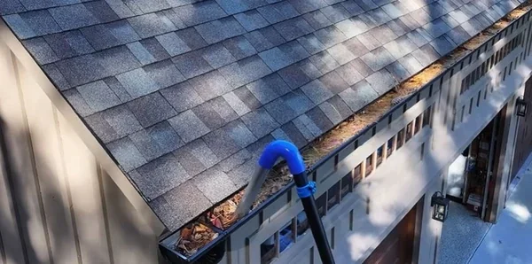 Debris buildup in a gutter, a sign it needs cleaning in Richmond, VA