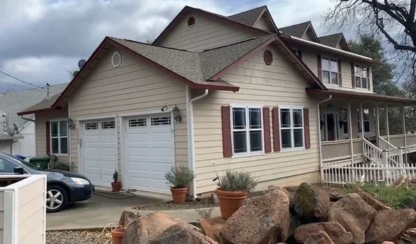A home with gutters recently cleaned, reducing basement flooding risk in Richmond, VA