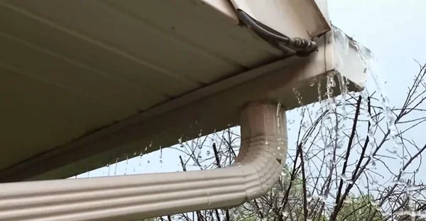 Roof rainwater draining into a gutter, part of a Richmond, VA home's impervious surface runoff